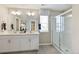 Bright bathroom featuring a double vanity with modern fixtures and a glass-enclosed shower at 3193 Belleville Ridge Rd, Elizabeth, CO 80107