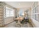 Bright dining area with a wooden table, blue chairs, and decorative windmill accents at 3193 Belleville Ridge Rd, Elizabeth, CO 80107