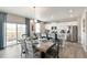 Bright dining area open to the kitchen, featuring a stylish table setting and sliding glass doors to the patio at 3193 Belleville Ridge Rd, Elizabeth, CO 80107