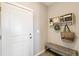 Inviting entryway featuring a white door, bench seating, and decorative wall accents at 3193 Belleville Ridge Rd, Elizabeth, CO 80107