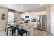 Modern kitchen with white cabinetry, stainless steel appliances, and a center island with bar seating at 3193 Belleville Ridge Rd, Elizabeth, CO 80107