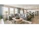 Bright, modern living room with a large sectional sofa, neutral colors, and an adjacent kitchen area at 3193 Belleville Ridge Rd, Elizabeth, CO 80107