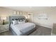 Calm main bedroom with a tufted bed, neutral colors, and a view of the ensuite bathroom at 3193 Belleville Ridge Rd, Elizabeth, CO 80107