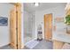 Bathroom featuring a glass shower, double sinks with wood cabinets, and wood doors at 10786 Marclif Rd, Conifer, CO 80433
