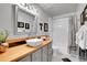 Bright bathroom featuring wood counters, vessel sink, modern fixtures, and tub with shower at 10786 Marclif Rd, Conifer, CO 80433