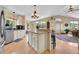 Open concept kitchen with stainless appliances, eat in breakfast bar, and lots of natural light at 10786 Marclif Rd, Conifer, CO 80433