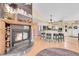 A modern living room with white cabinetry, hardwood floors, and a cozy stone fireplace at 10786 Marclif Rd, Conifer, CO 80433