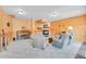 Cozy living room with a wood burning fireplace and rustic wood paneled walls at 10786 Marclif Rd, Conifer, CO 80433