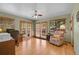 Home office featuring wood floors, a ceiling fan, and access to a deck at 10786 Marclif Rd, Conifer, CO 80433
