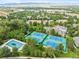 Aerial view of a community featuring tennis courts, a pool, and lush green landscaping at 2783 W Long Dr # B, Littleton, CO 80120