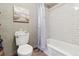 Cozy bathroom featuring a toilet and a shower/tub with white subway tile for a clean, modern look at 2783 W Long Dr # B, Littleton, CO 80120