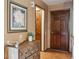 Warm and inviting hallway showcasing rich wood doors and a decorative chest for a touch of elegance at 2783 W Long Dr # B, Littleton, CO 80120
