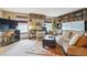 Well-organized living area with natural light, custom shelving, comfortable seating, and a dedicated workspace for productivity at 2783 W Long Dr # B, Littleton, CO 80120