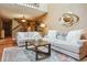 Bright living room featuring soaring ceilings, tile floors, plush furniture and decorator touches for a warm and inviting space at 2783 W Long Dr # B, Littleton, CO 80120