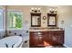 Elegant bathroom with double vanity, granite countertop, and soaking tub at 9602 S Hackberry St, Highlands Ranch, CO 80129