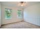 Neutral bedroom with carpet, two windows, and a ceiling fan at 9602 S Hackberry St, Highlands Ranch, CO 80129