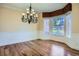 Elegant dining room with hardwood floors, chandelier, and bay window at 9602 S Hackberry St, Highlands Ranch, CO 80129