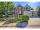 Beautiful two-story brick home with a three-car garage and landscaped front yard at 9602 S Hackberry St, Highlands Ranch, CO 80129