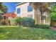 View of the home's exterior highlighting manicured landscaping and large windows for ample natural light at 9602 S Hackberry St, Highlands Ranch, CO 80129