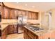 A kitchen featuring granite countertops, stainless steel appliances, and wooden cabinets at 9602 S Hackberry St, Highlands Ranch, CO 80129