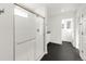 Modern bathroom with large shower, glass door, black herringbone floors, and white tiling at 10152 Yampa Ct, Commerce City, CO 80022