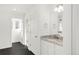 Bathroom with granite countertop vanity, black floors, modern fixtures, and white doors at 10152 Yampa Ct, Commerce City, CO 80022