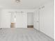 Bright bedroom with white walls, gray carpet, and sliding barn door to bathroom at 10152 Yampa Ct, Commerce City, CO 80022