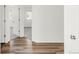 Hallway with wood-look flooring leading to various rooms, creating an inviting transition space at 10152 Yampa Ct, Commerce City, CO 80022