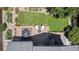 Aerial view showcasing the backyard deck, patio furniture, fire pit, and lush greenery, creating a private outdoor oasis at 5323 E Hamilton Ave, Castle Rock, CO 80104