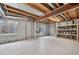 Spacious unfinished basement with windows, concrete walls, and wooden support beams at 5323 E Hamilton Ave, Castle Rock, CO 80104