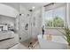 Spa-like bathroom with a soaking tub, glass-enclosed shower, and elegant finishes at 5323 E Hamilton Ave, Castle Rock, CO 80104