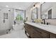 Bright bathroom features dual sinks, soaking tub, and glass-enclosed shower with marble tile at 5323 E Hamilton Ave, Castle Rock, CO 80104