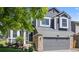 Charming two-story home with gray siding, stone accents, and a well-manicured front yard at 5323 E Hamilton Ave, Castle Rock, CO 80104