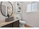 Stylish half-bath with a vessel sink, marble countertop, modern faucet, and decorative shelving at 5323 E Hamilton Ave, Castle Rock, CO 80104