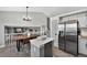 Open-concept kitchen and dining area with stainless steel appliances and a large island at 5323 E Hamilton Ave, Castle Rock, CO 80104