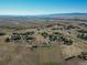 Stunning aerial view of a vibrant neighborhood with luxury homes, rolling land, and great mountain vistas at 6242 W Lakeside Ct, Littleton, CO 80125