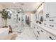 Bright bathroom featuring a glass-enclosed shower, a soaking tub, and white cabinetry at 6242 W Lakeside Ct, Littleton, CO 80125