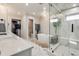 Bathroom showcasing double vanity sinks, a soaking tub, a glass-enclosed shower, and contemporary fixtures at 6242 W Lakeside Ct, Littleton, CO 80125