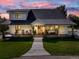 Charming two-story home featuring a welcoming front porch with rocking chairs and a well-manicured front lawn at 6242 W Lakeside Ct, Littleton, CO 80125