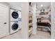 A combined laundry and pantry space featuring a stacked washer/dryer and organized pantry shelves at 6242 W Lakeside Ct, Littleton, CO 80125