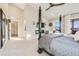 Cozy main bedroom with a four-poster bed, a sitting area, and views of the outdoors at 6242 W Lakeside Ct, Littleton, CO 80125