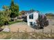 Expansive backyard featuring a deck, large windows, and lush greenery, offering a private and serene outdoor space at 6242 W Lakeside Ct, Littleton, CO 80125