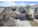 Aerial view of a well-maintained home showcasing a driveway, garage and landscaping at 9443 Palisade Ct, Highlands Ranch, CO 80130