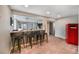 Modern basement bar featuring a countertop, bar stools, and a retro fridge at 9443 Palisade Ct, Highlands Ranch, CO 80130