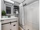 Modern bathroom with white vanity, decorative mirror and updated walk-in shower at 9443 Palisade Ct, Highlands Ranch, CO 80130