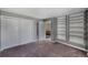 This bedroom features built in shelving, plush carpet and a large closet for storage at 9443 Palisade Ct, Highlands Ranch, CO 80130