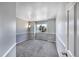 Cozy bedroom with soft gray carpet, chair railing, and a bright window view at 9443 Palisade Ct, Highlands Ranch, CO 80130