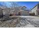 Charming two-story home with brick accents, a manicured lawn, and a two-car garage at 9443 Palisade Ct, Highlands Ranch, CO 80130