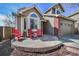 Charming front porch with three red chairs and neutral-toned home exterior at 9443 Palisade Ct, Highlands Ranch, CO 80130