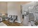 Hallway featuring hardwood floors, access to an open living area, and a staircase at 9443 Palisade Ct, Highlands Ranch, CO 80130